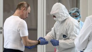 El presidente ruso, Vladimir Putin, junto a un médico con traje de protección