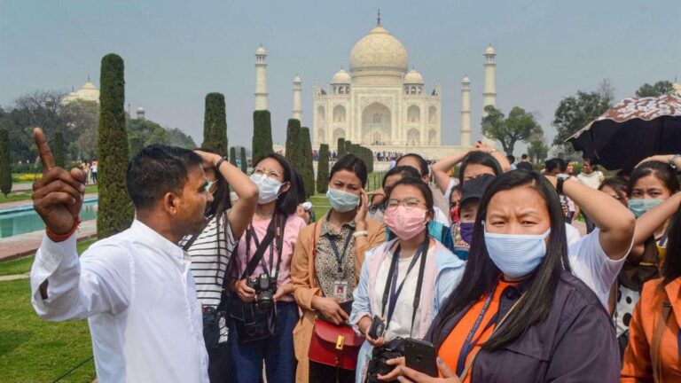 Turistas con mascarillas en una visita al Taj Mahal