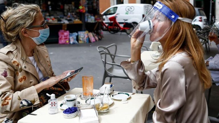 Dos personas sentadas en una terraza en Roma italia coronavirus