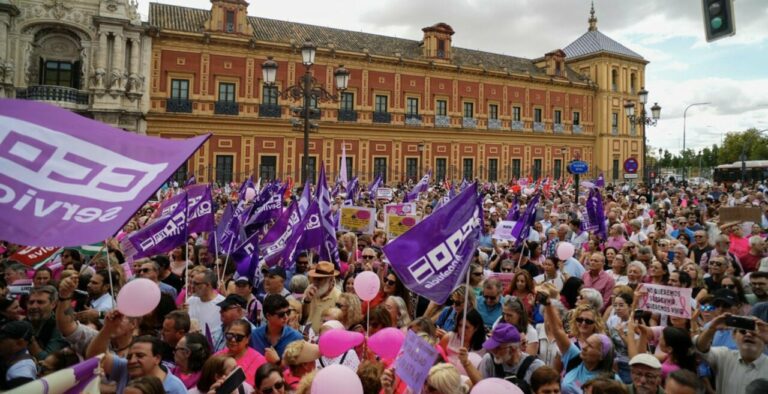 Multitud de personas en Sevilla con pancartas y banderas durante la movilización.