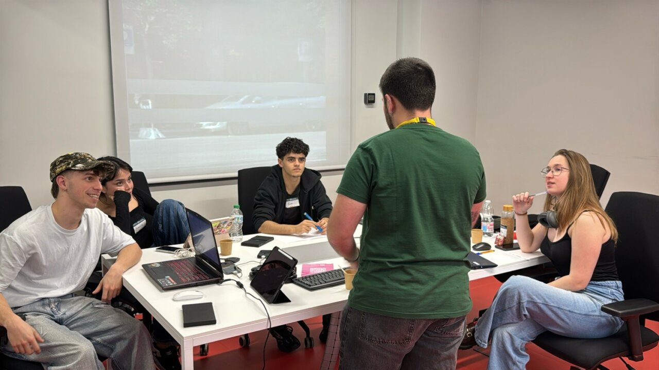 Grupo de j&oacute;venes trabajando en un hackathon sobre soluciones de WhatsApp